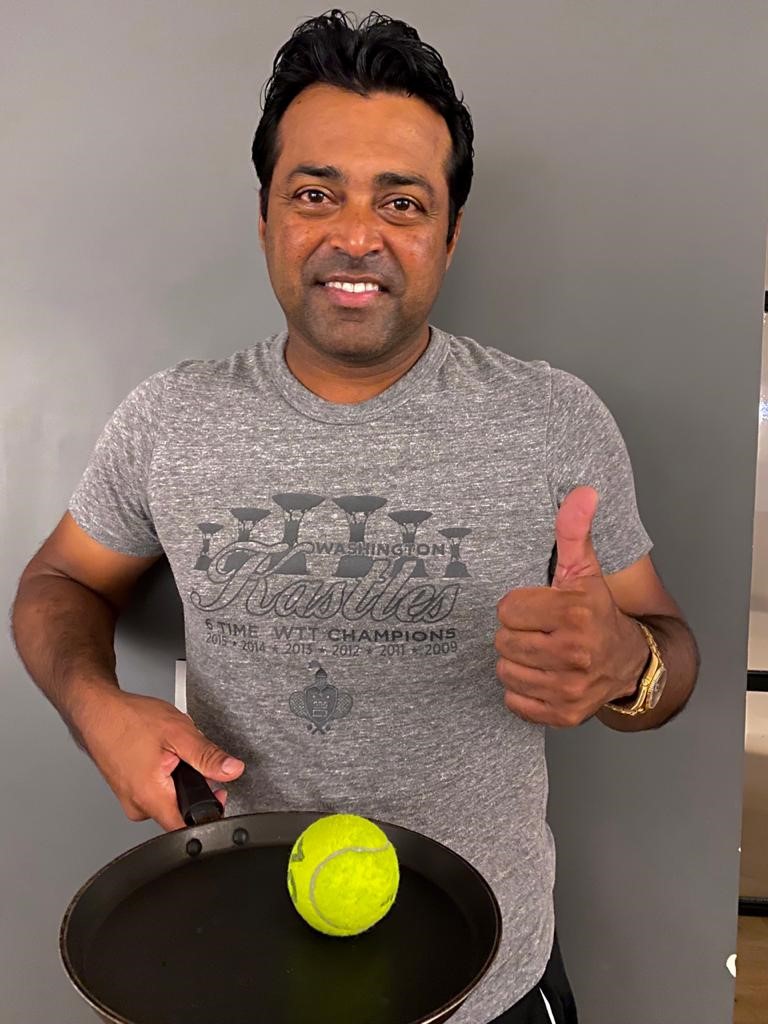 Leander Paes holding tennis ball in frying pan