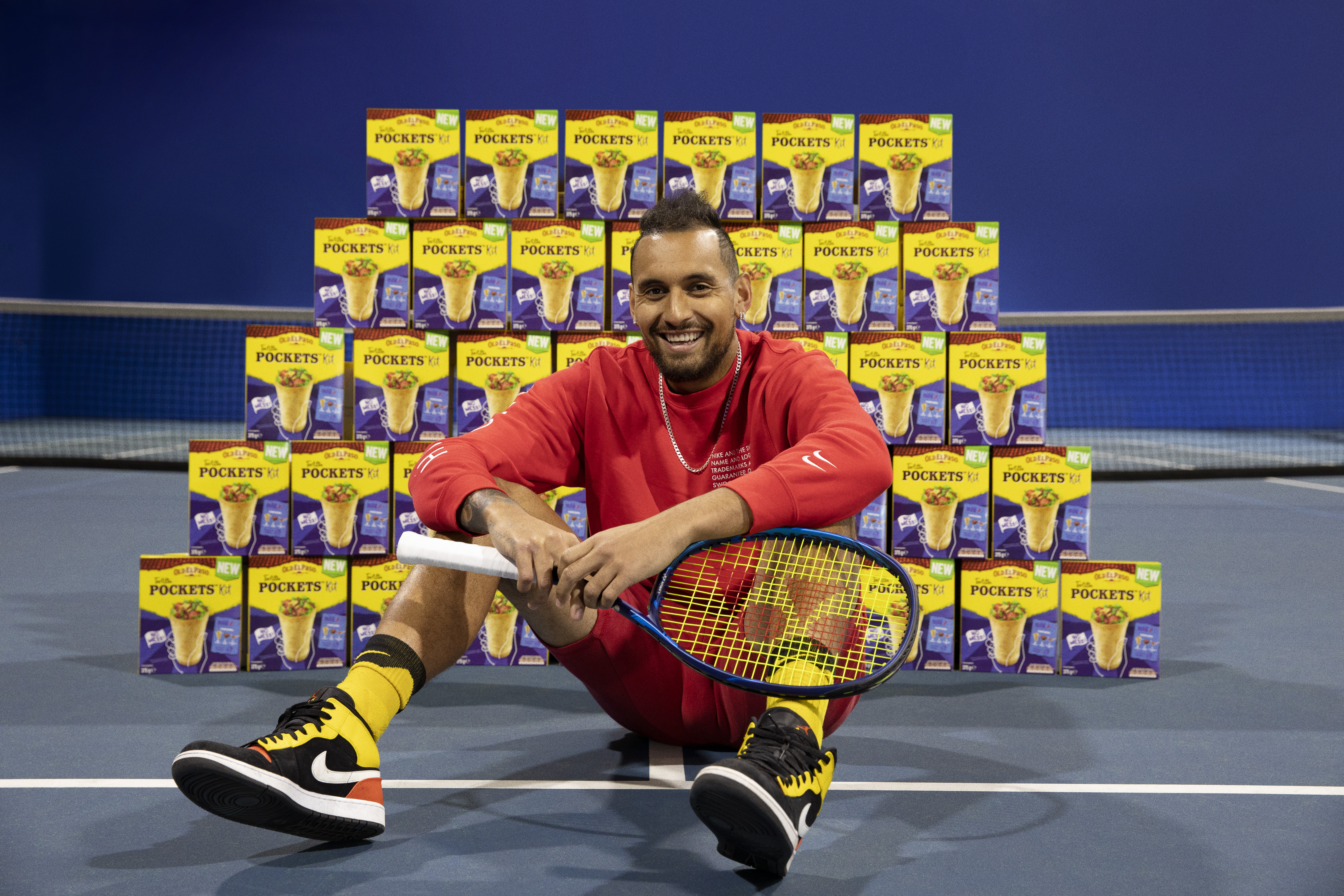 Tennis star Nick Kyrgios in front of wall of tortilla pockets