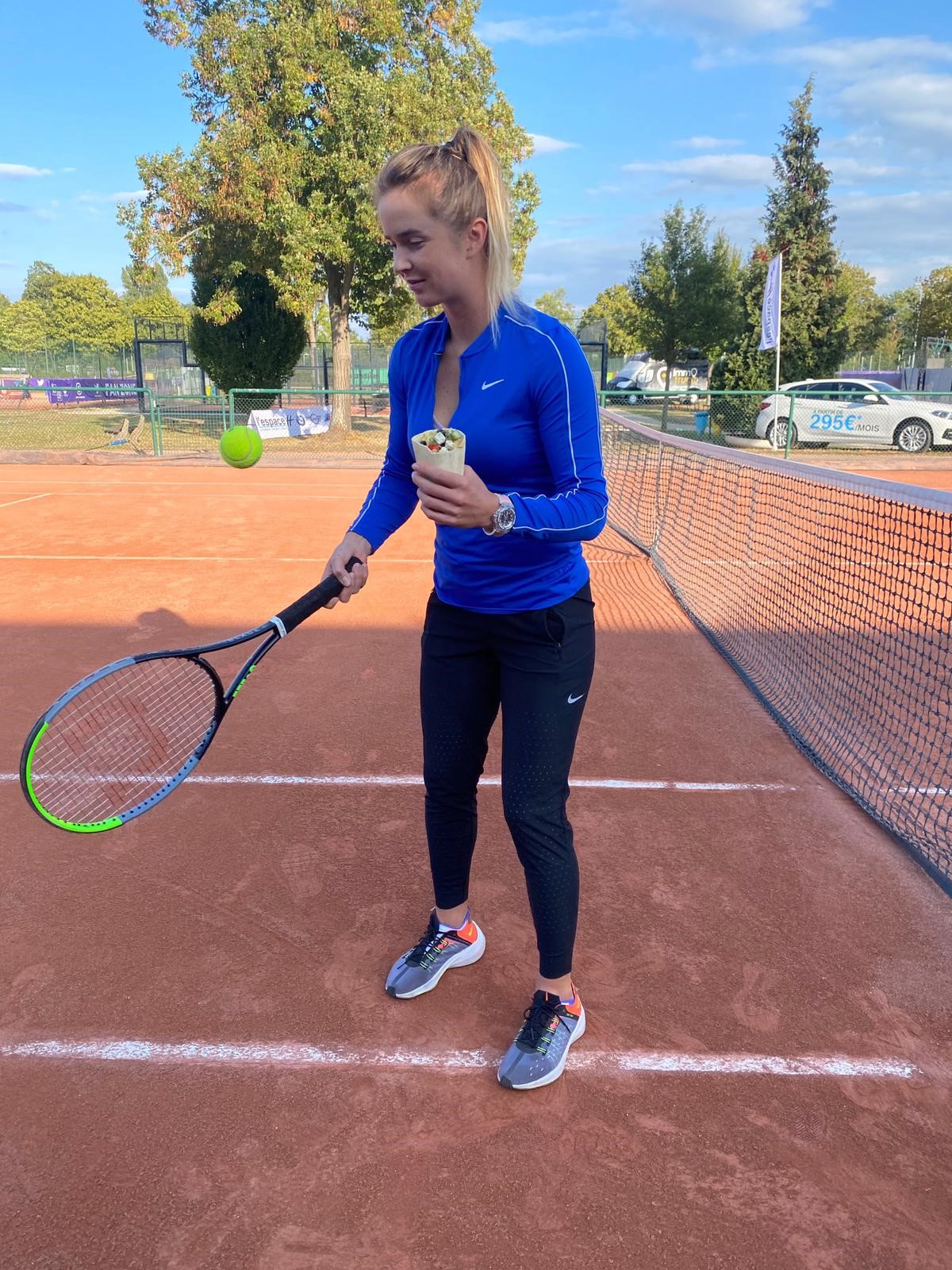 Tennis player bouncing ball on racket while holding tortilla pocket